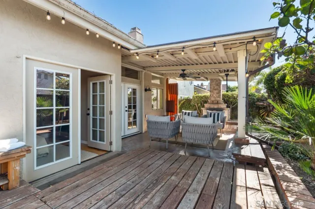 a balcony with furniture and a potted plant