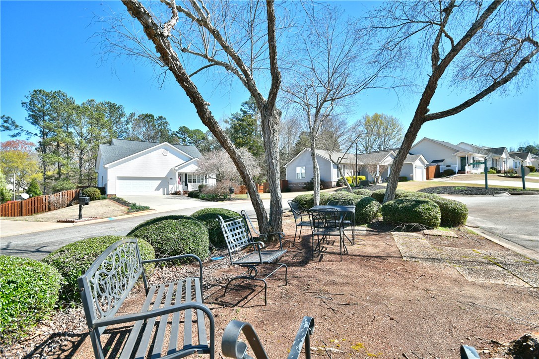 103 Baldwin Place Easley, SC 29642 - Photo 11 of 42 Enjoy the inviting neighborhood ambiance from this charming outdoor seating area.