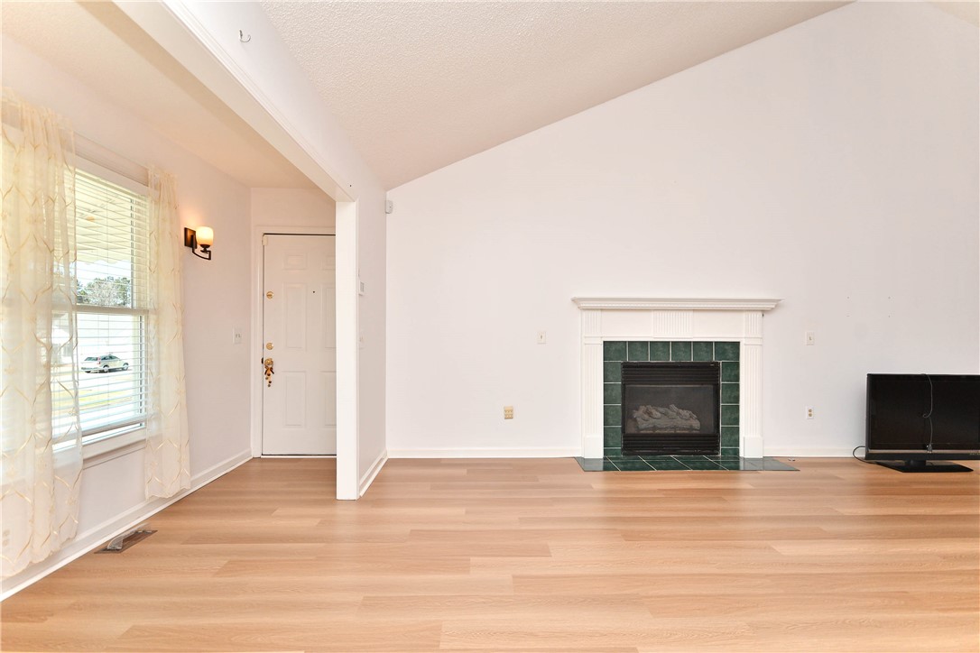 103 Baldwin Place Easley, SC 29642 - Photo 15 of 42 This bright living space features sleek wood flooring and a cozy fireplace, perfect for quiet evenings.