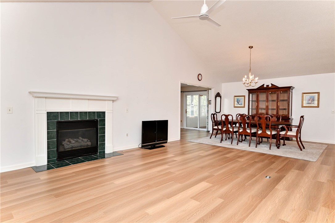 103 Baldwin Place Easley, SC 29642 - Photo 16 of 42 Bright and airy living and dining areas offer a fireplace and vaulted ceilings.