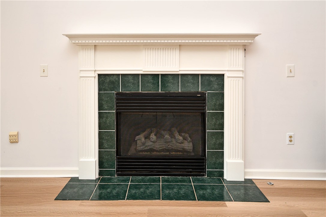 103 Baldwin Place Easley, SC 29642 - Photo 17 of 42 This living room features a fireplace with elegant white molding and a tiled surround.