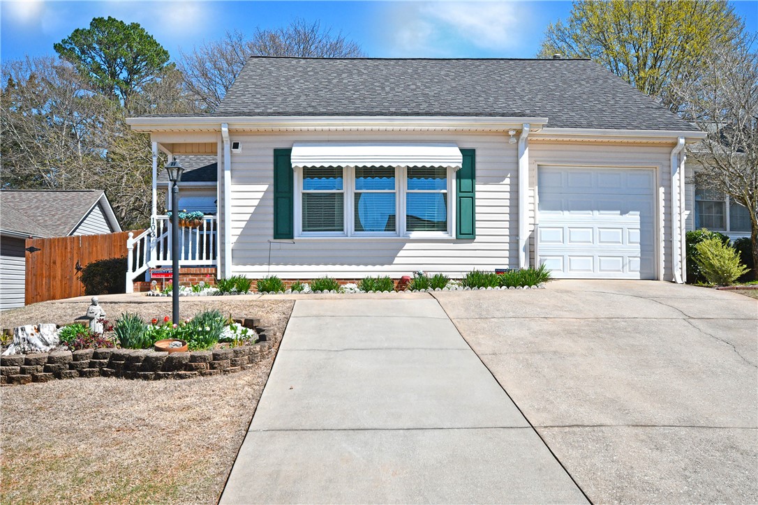 103 Baldwin Place Easley, SC 29642 - Photo 2 of 42 This charming residence features an inviting facade with a concrete driveway and an attached garage.