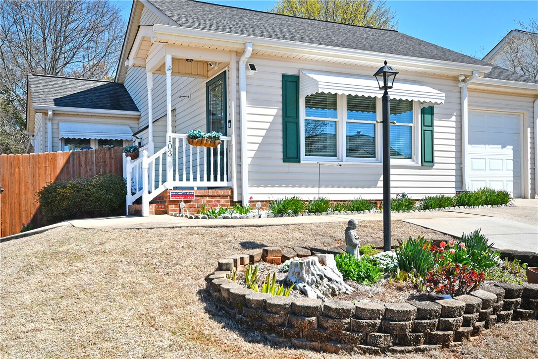 103 Baldwin Place Easley, SC 29642 - Photo 3 of 42 This charming home offers a welcoming facade with lush landscaping and an inviting front entrance.
