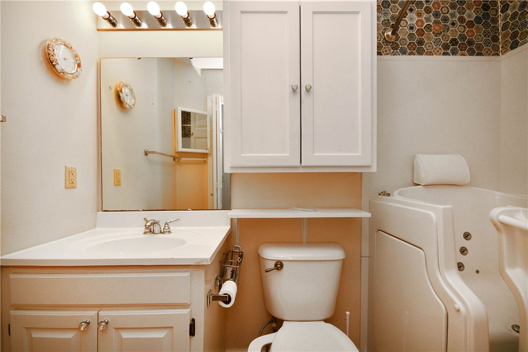 103 Baldwin Place Easley, SC 29642 - Photo 33 of 42 A well-appointed bathroom features a walk-in tub and vanity, perfect for relaxation.