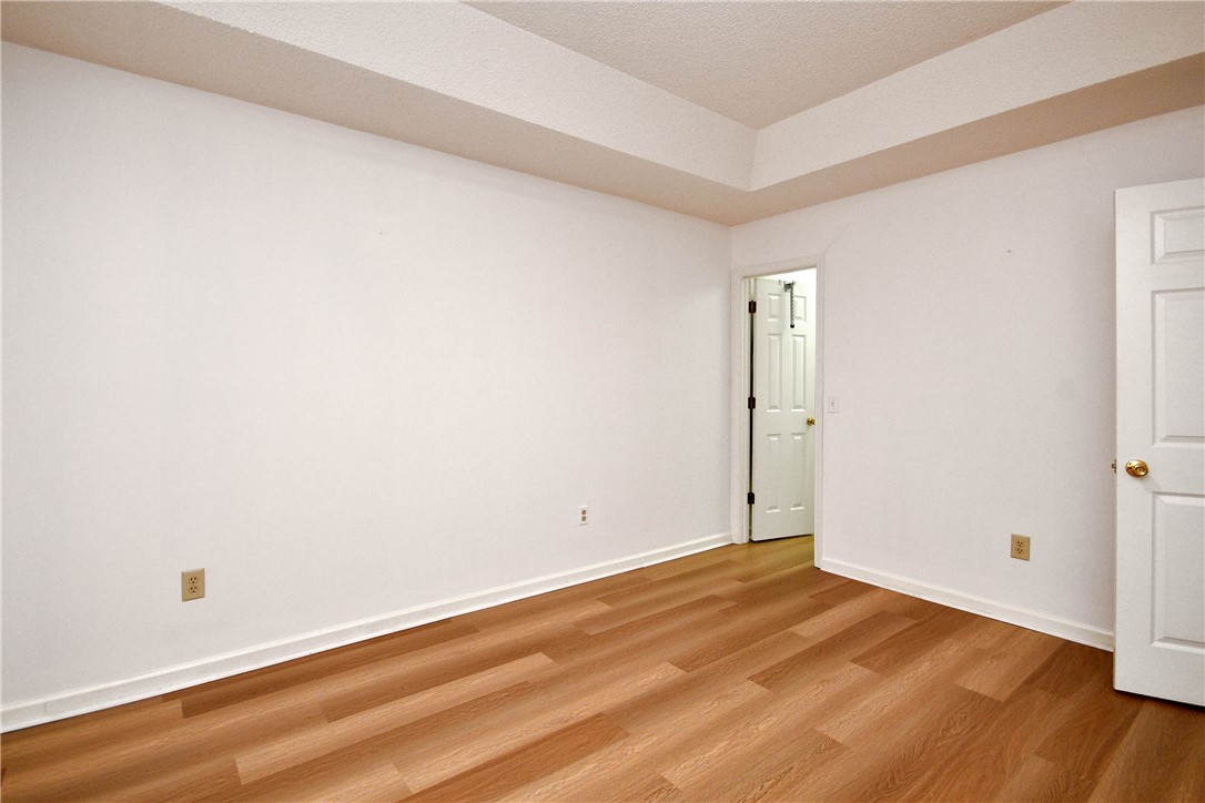 103 Baldwin Place Easley, SC 29642 - Photo 36 of 42 This bright room features a spacious tray ceiling and rich wood-style flooring.