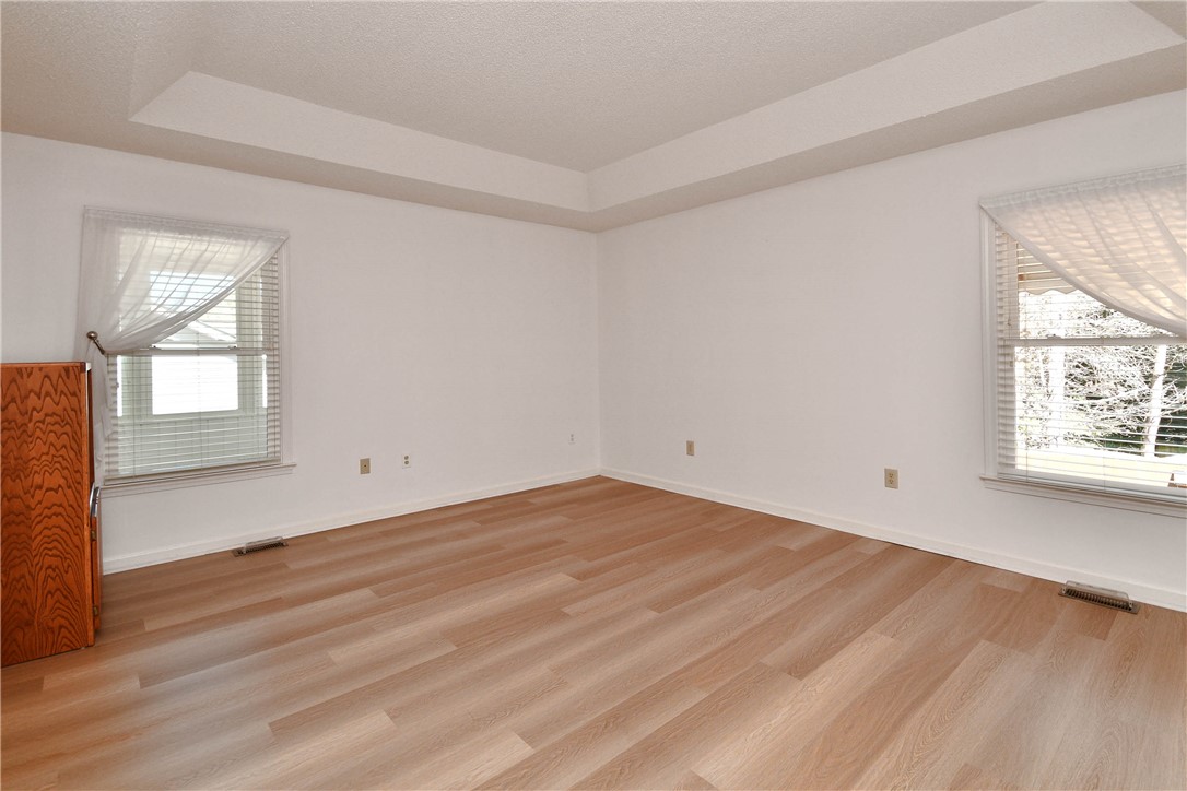 103 Baldwin Place Easley, SC 29642 - Photo 39 of 42 This spacious bedroom features warm wood flooring and abundant natural light through multiple windows.