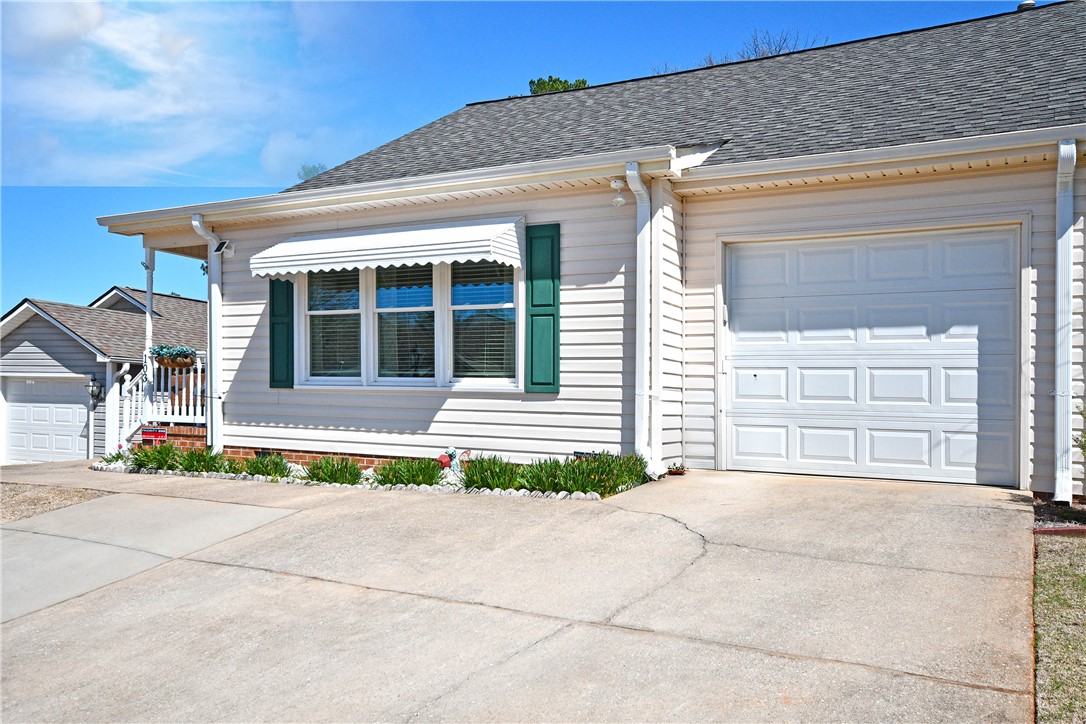 103 Baldwin Place Easley, SC 29642 - Photo 4 of 42 This charming home offers a convenient garage and a welcoming front porch, perfect for daily living.