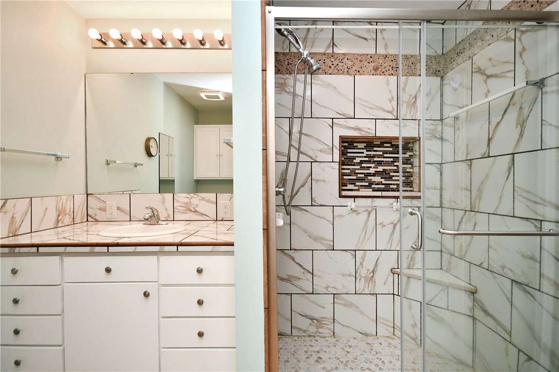 103 Baldwin Place Easley, SC 29642 - Photo 42 of 42 This bathroom features a contemporary vanity and a tiled shower with elegant accents.