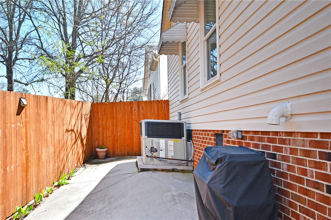 103 Baldwin Place Easley, SC 29642 - Photo 10 of 42 This exterior view showcases a well-maintained side yard with practical features.
