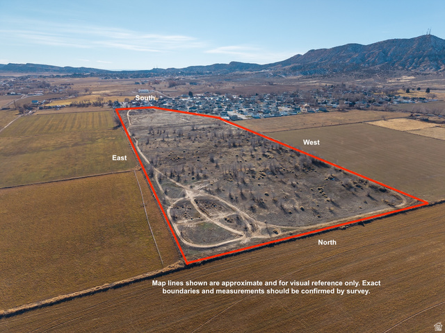 3073 West 500 South Vernal, UT 84078 - Photo 3 of 8 Aerial view of sparsely populated area with property boundaries highlighted and mountains