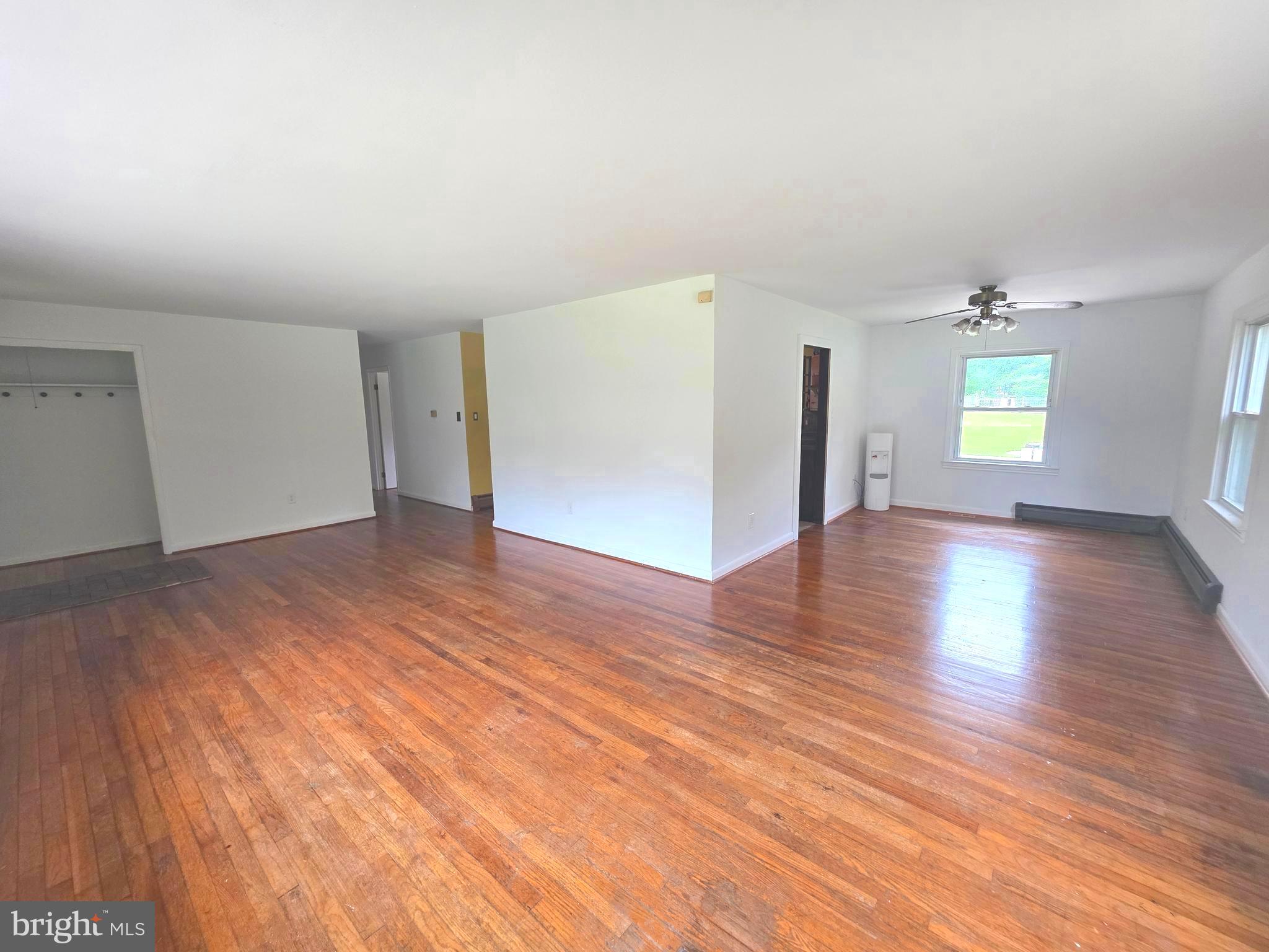 8920 Marshall Corner Road Pomfret, MD 20675 - Photo 10 of 31 an empty room with wooden floor and windows