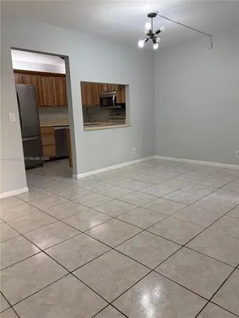 an empty room with windows and fireplace