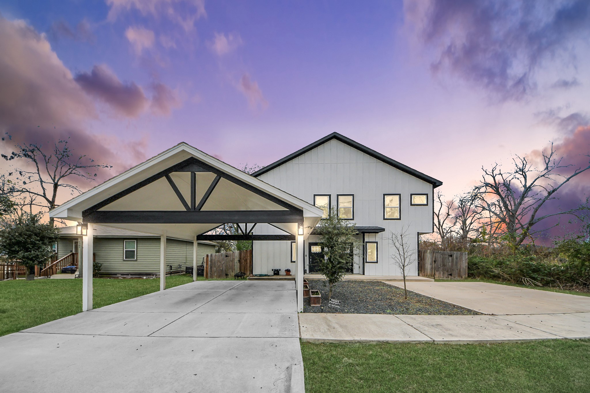 a front view of a house with a garden and trees