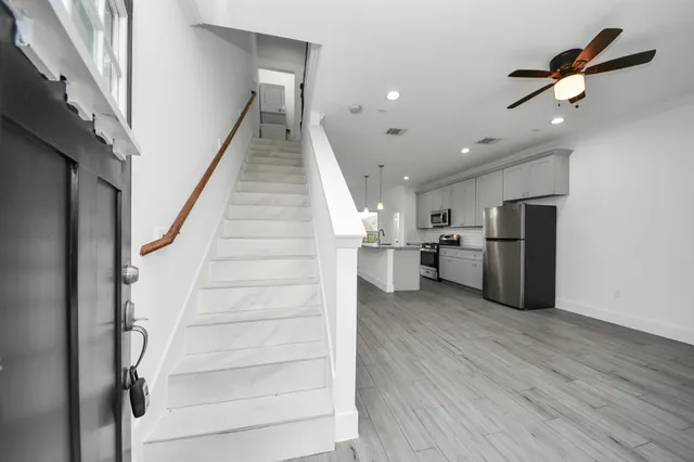 a view of entryway and hall with wooden floor