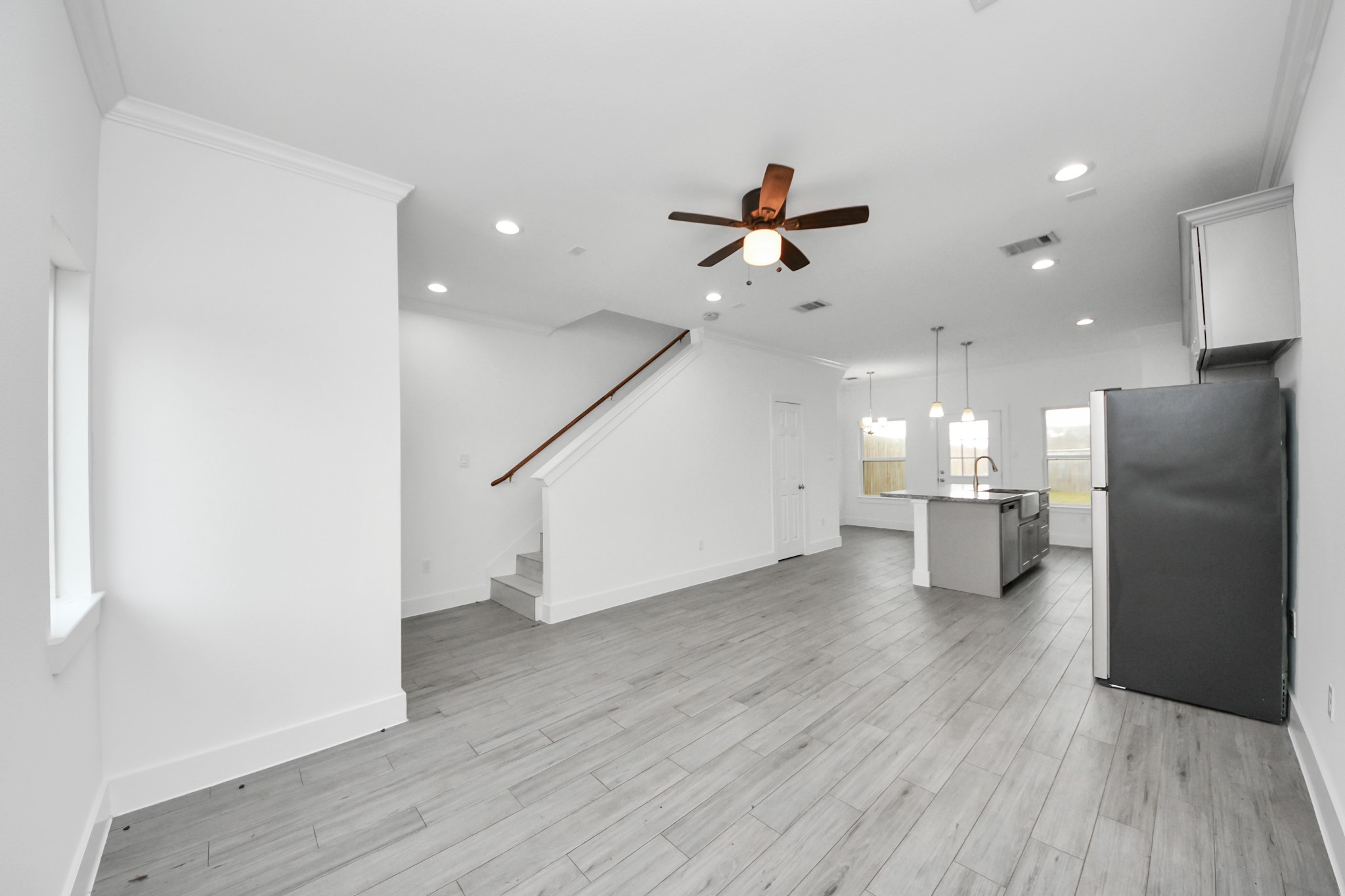 8305 Prairie View Drive, Unit B Houston, TX 77088 - Photo 5 of 22 Modern, open concept living area with light wood flooring, equipped with a ceiling fan, and recessed lighting
