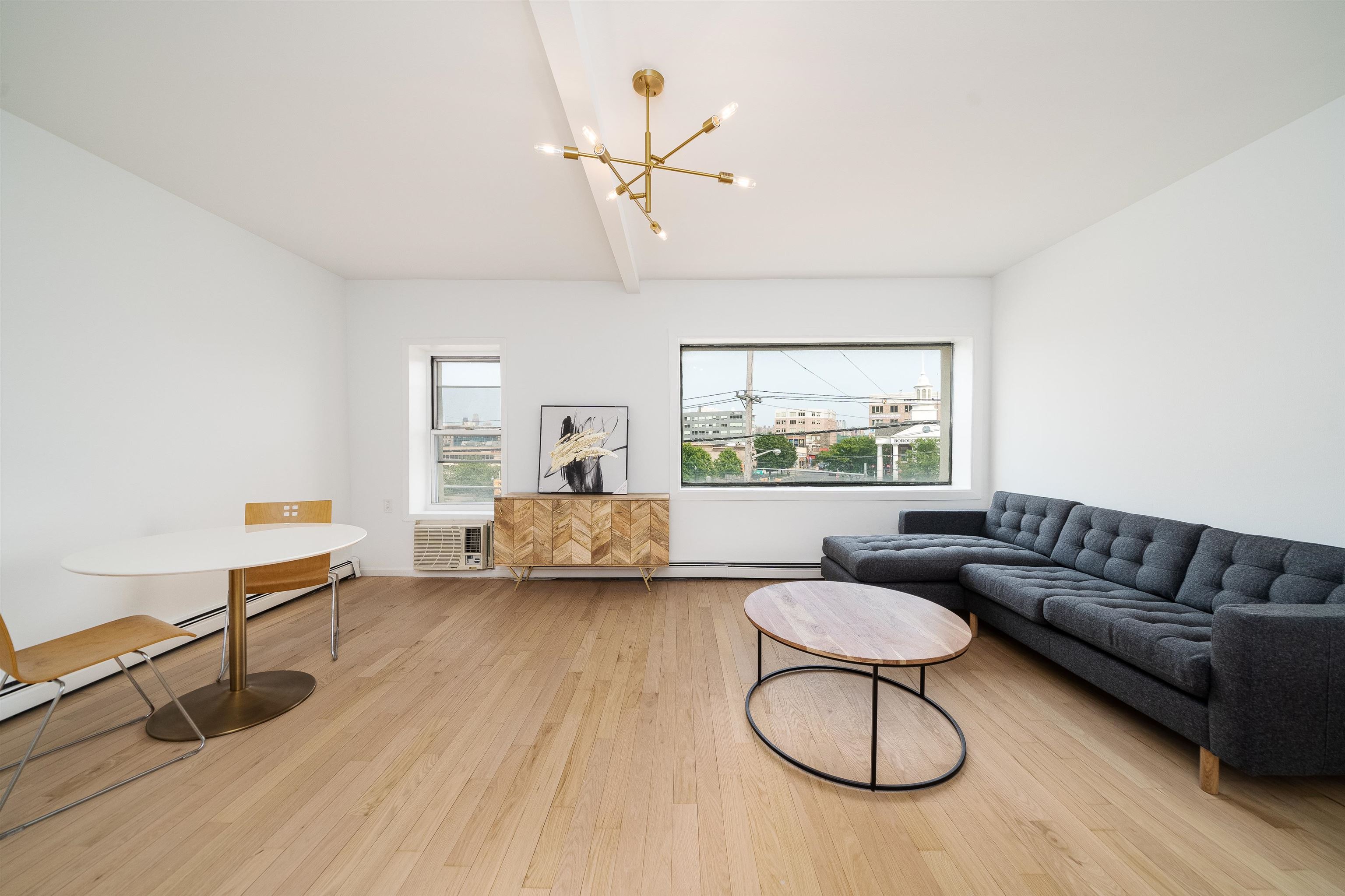 8905 Old River Road, Unit 3 Edgewater, NJ 07047 - Photo 11 of 18 a living room with furniture a window and a chandelier