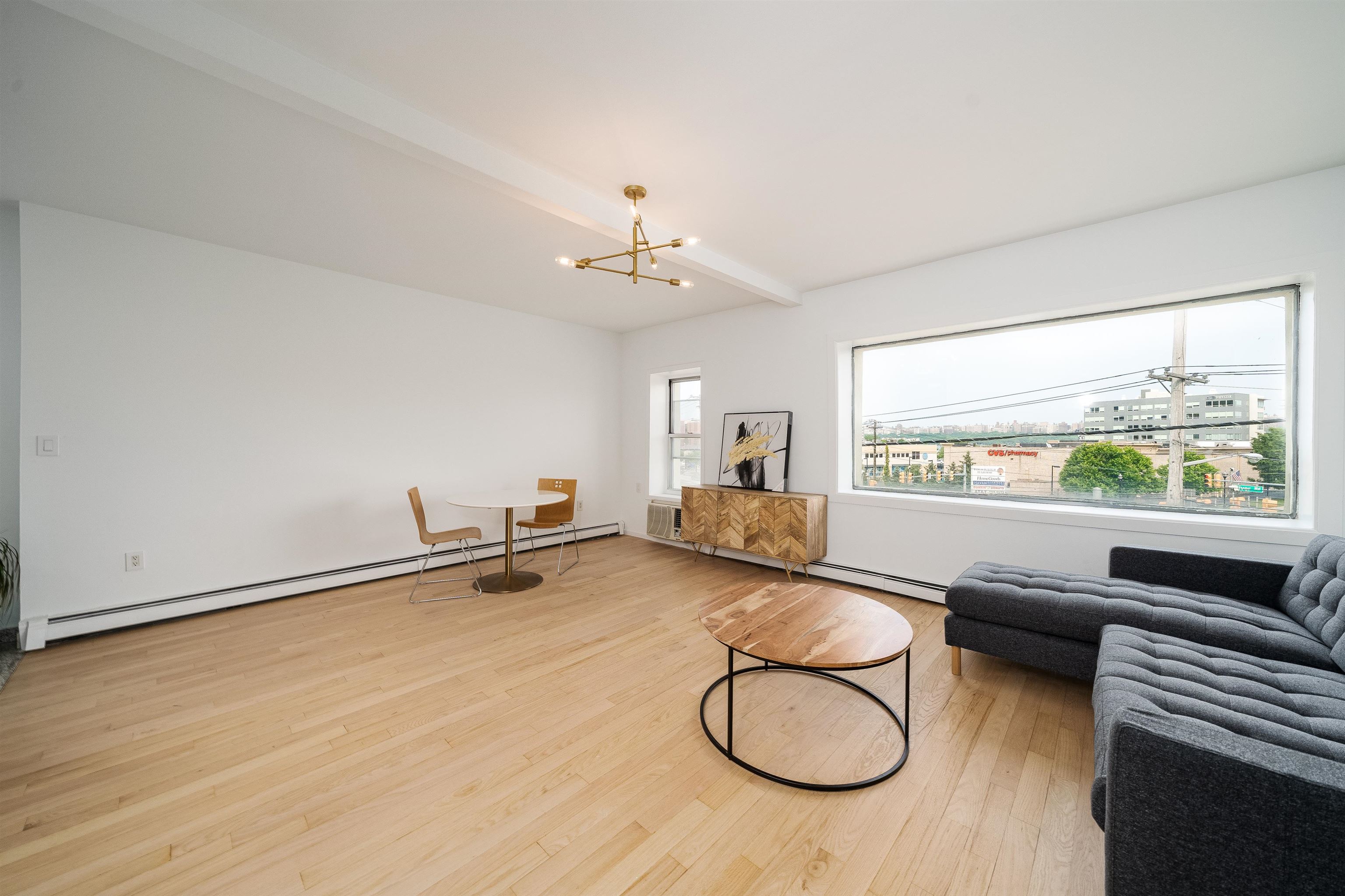 8905 Old River Road, Unit 3 Edgewater, NJ 07047 - Photo 12 of 18 a living room with furniture a window and a chandelier