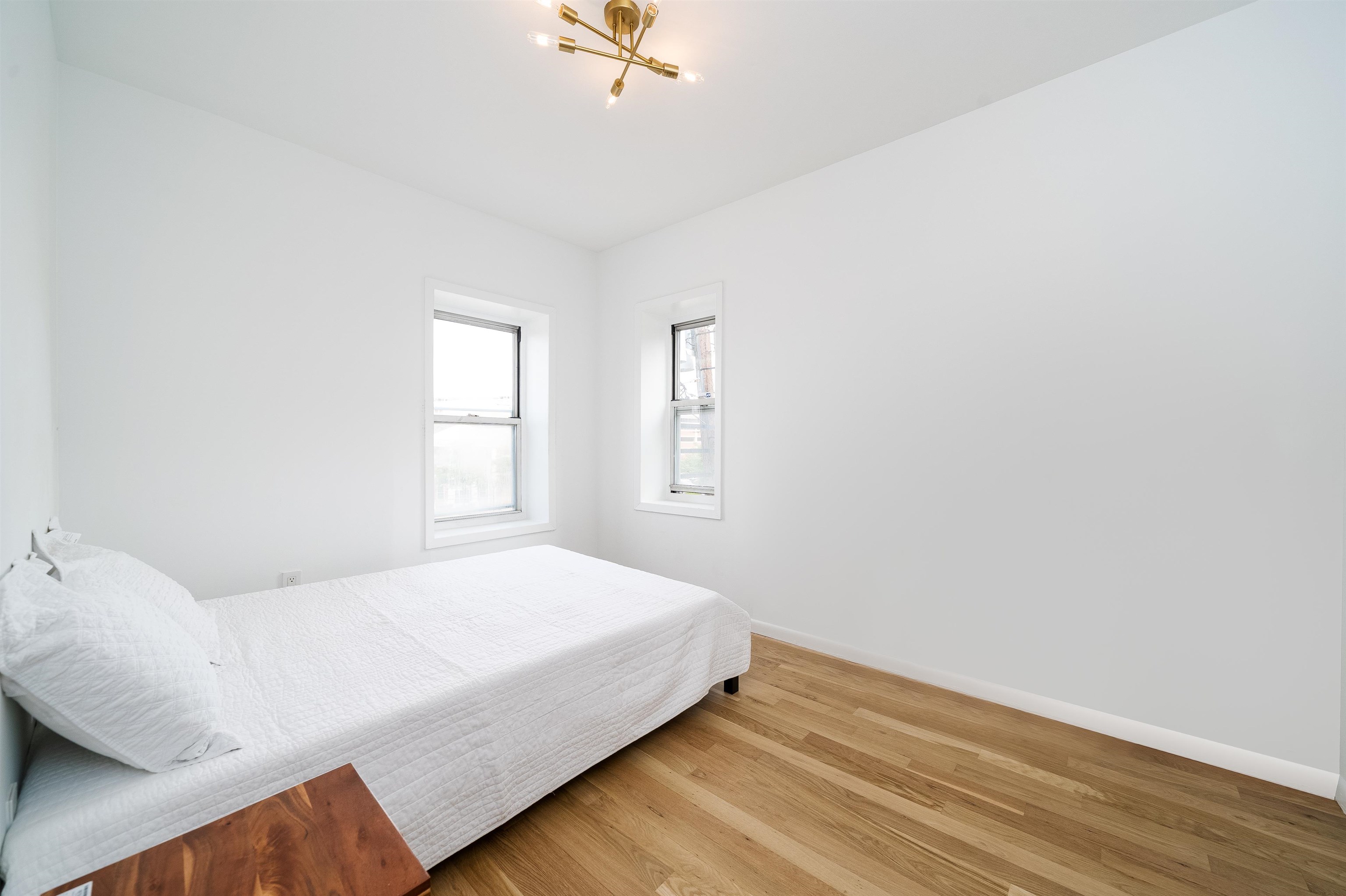 8905 Old River Road, Unit 3 Edgewater, NJ 07047 - Photo 3 of 18 a bedroom with a bed and a window