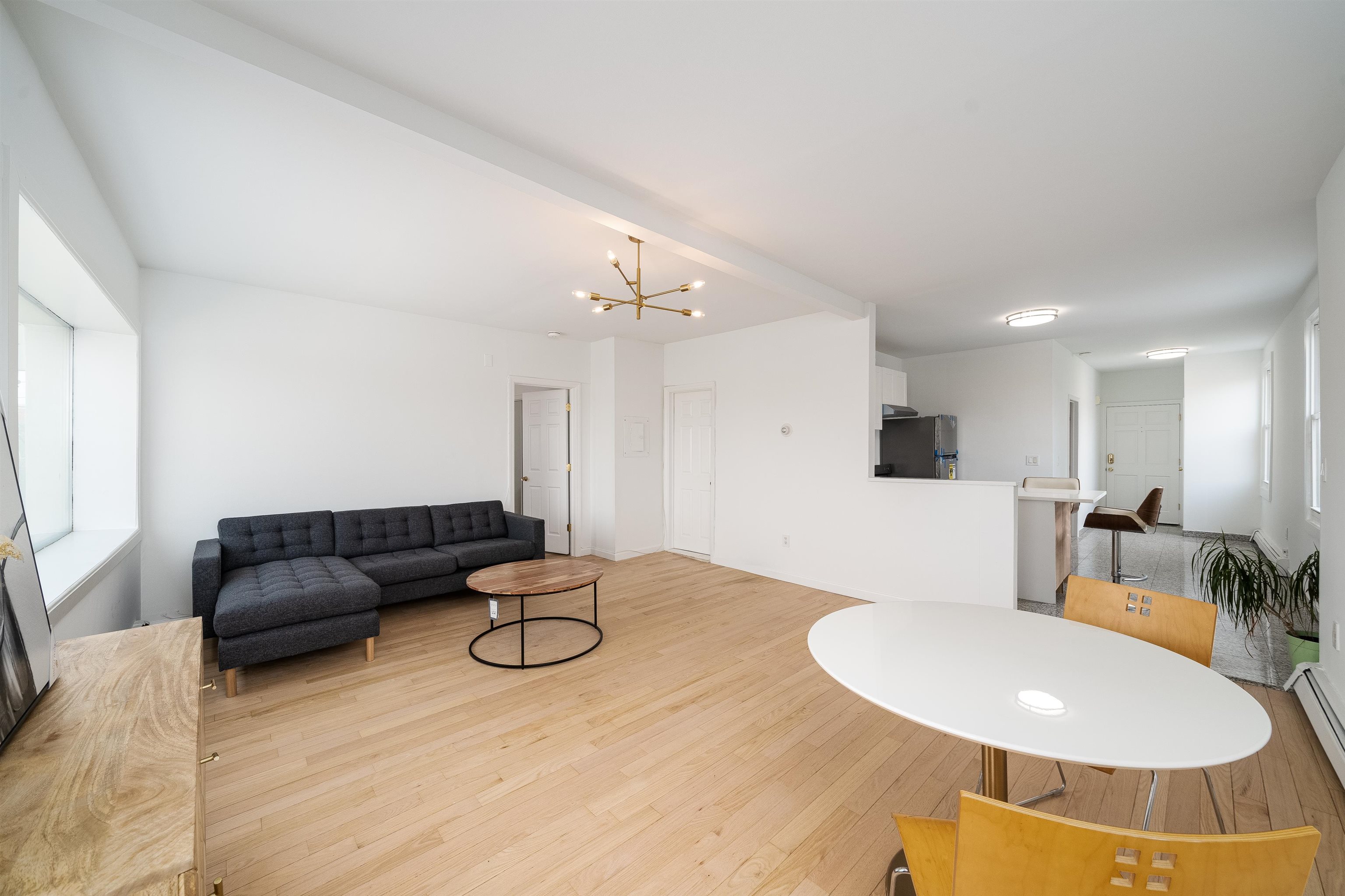 8905 Old River Road, Unit 3 Edgewater, NJ 07047 - Photo 10 of 18 a living room with furniture and a chandelier