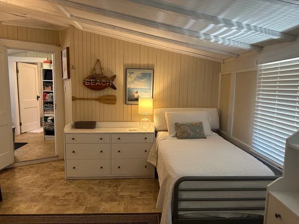 a bedroom with a bed and flat screen tv