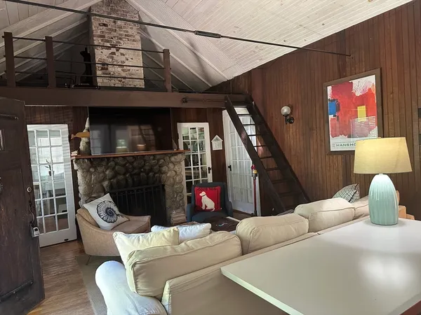 a living room with furniture a flat screen tv and a fireplace