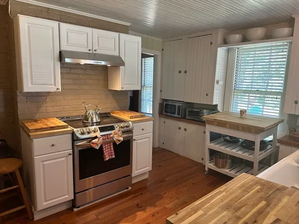 a kitchen with stainless steel appliances a stove a refrigerator and cabinets