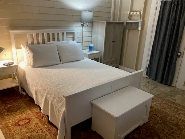 a bedroom with a bed and cabinets