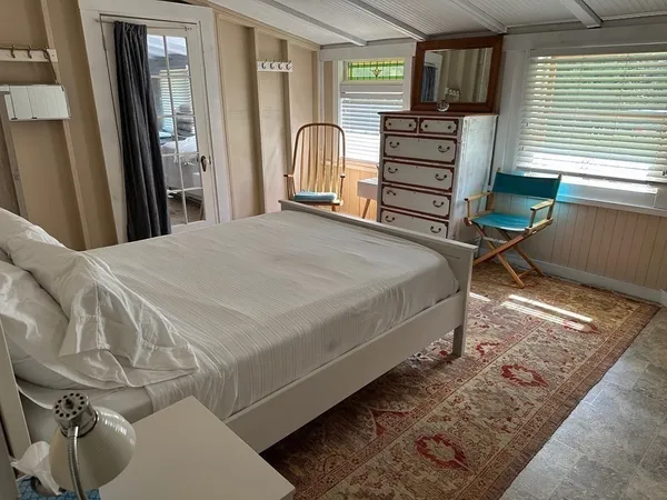 a bed room with a bed and a television