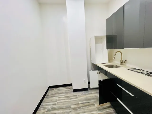 a close view of a sink and a utility room with a sink