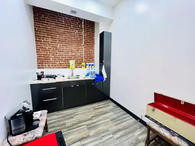 a view of a room with wooden floor and a window