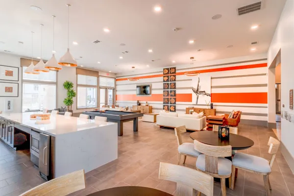 a large kitchen with a table and chairs