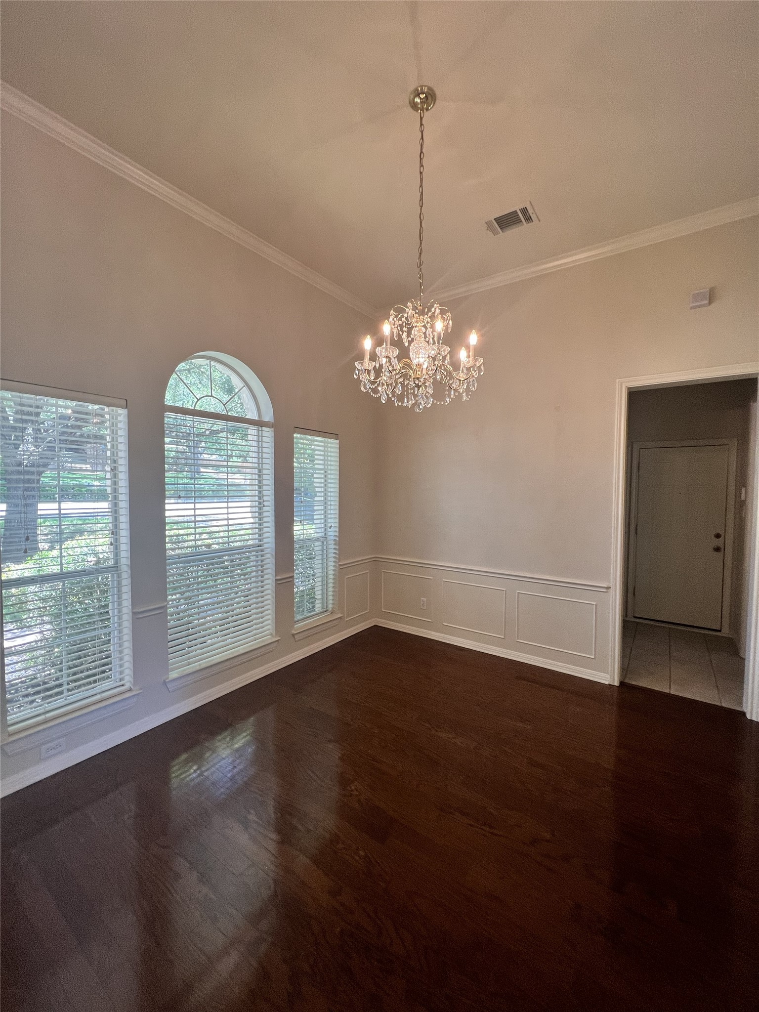 9405 Ashton Ridge Austin, TX 78750 - Photo 8 of 22 Refined dark hardwood floors anchor this elegant room, crowned by a glittering crystal chandelier.