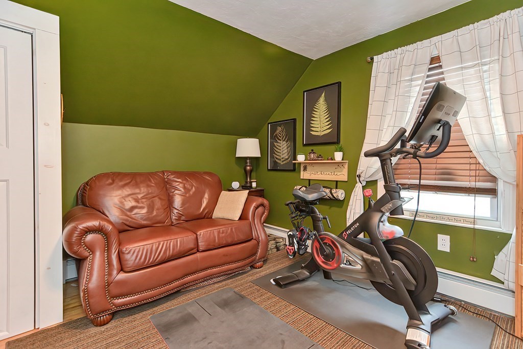 23 Dryden Street Worcester, MA 01605 - Photo 14 of 23 a living room with furniture a window and gym cycle