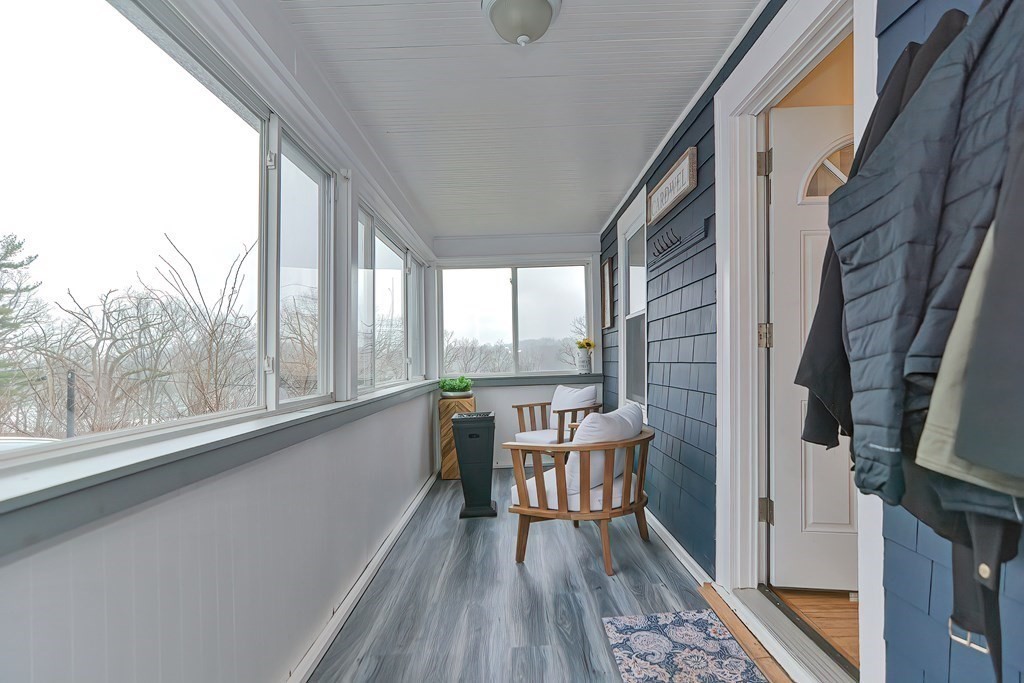 23 Dryden Street Worcester, MA 01605 - Photo 20 of 23 a view of a balcony with chairs and wooden floor