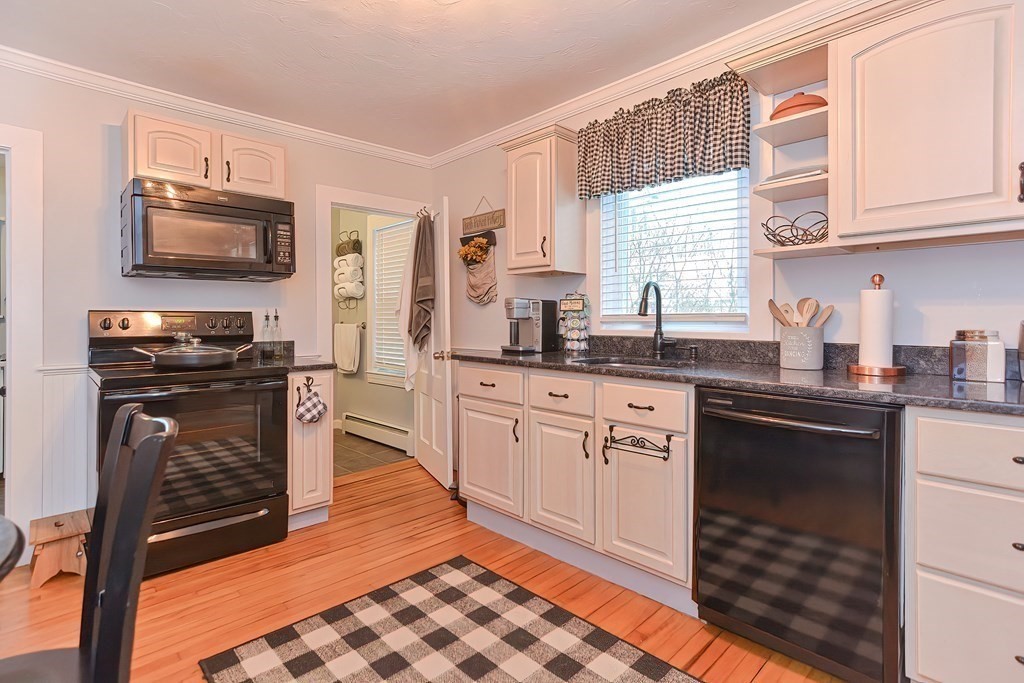 23 Dryden Street Worcester, MA 01605 - Photo 5 of 23 a kitchen with stainless steel appliances granite countertop a stove a sink and a microwave