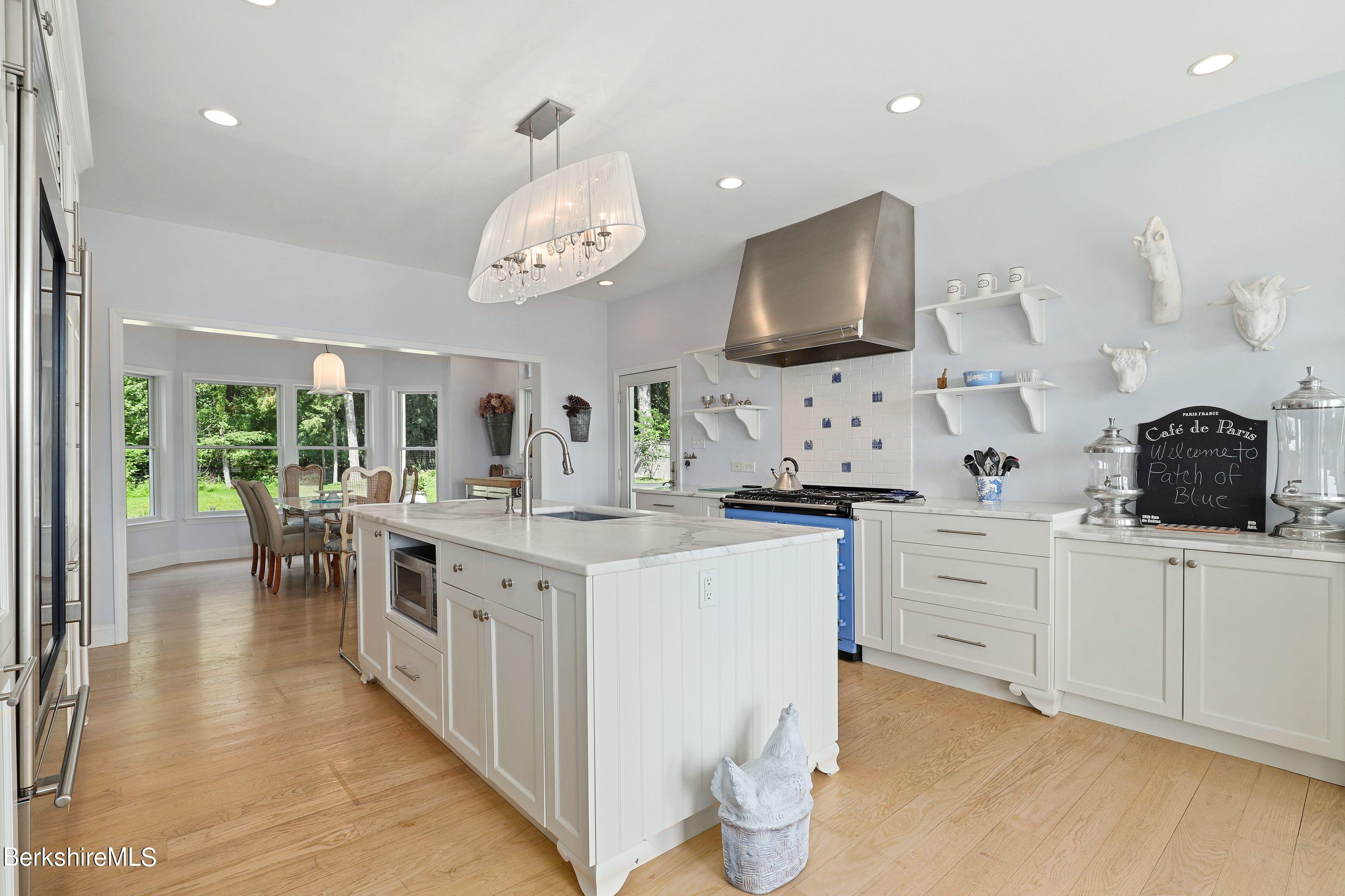 271 B Lakeview Road Craryville, NY 12521 - Photo 5 of 23 a kitchen with stainless steel appliances a white stove top oven a sink dishwasher and white cabinets with wooden floor