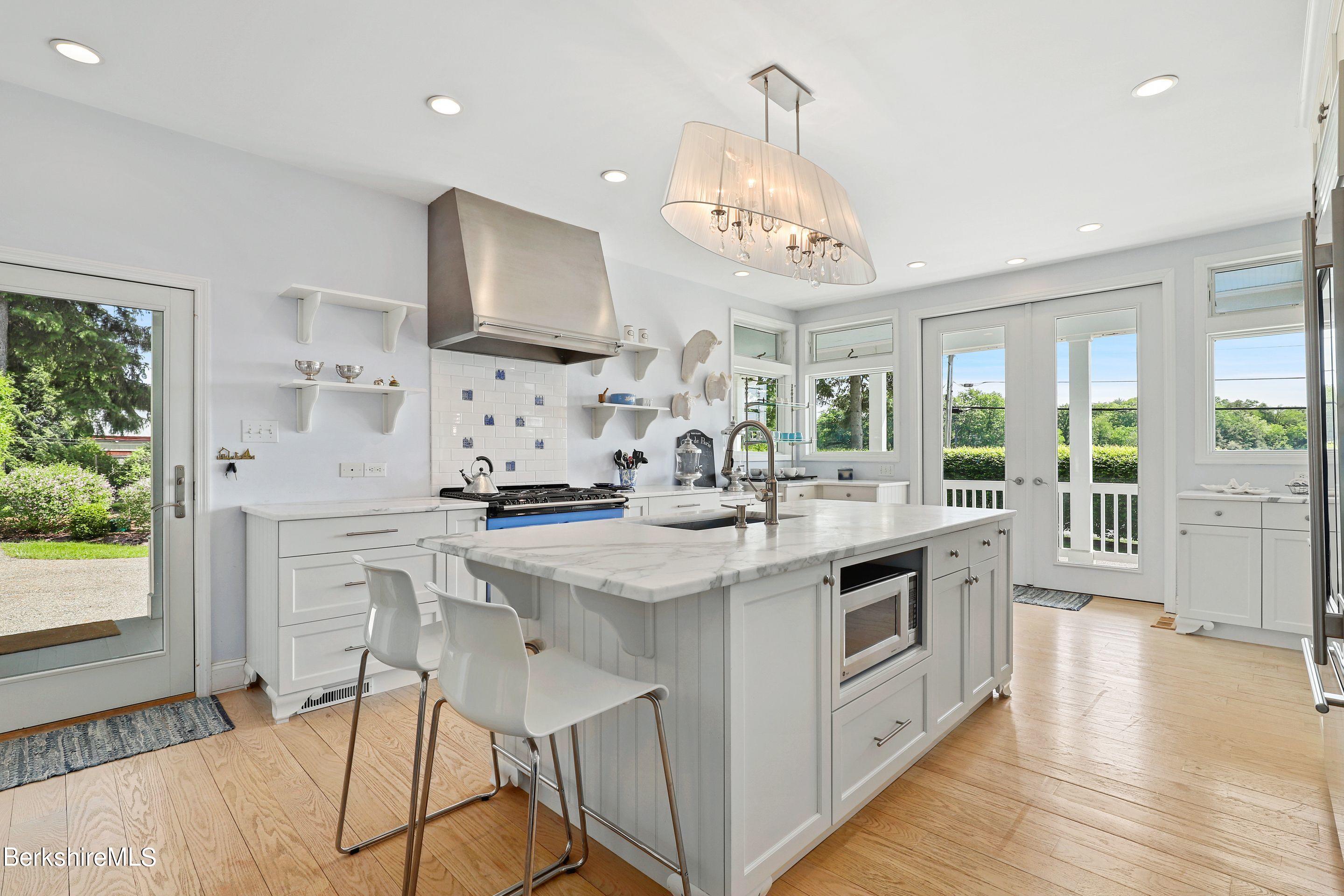 271 B Lakeview Road Craryville, NY 12521 - Photo 6 of 23 a kitchen with stainless steel appliances a sink stove and wooden floor