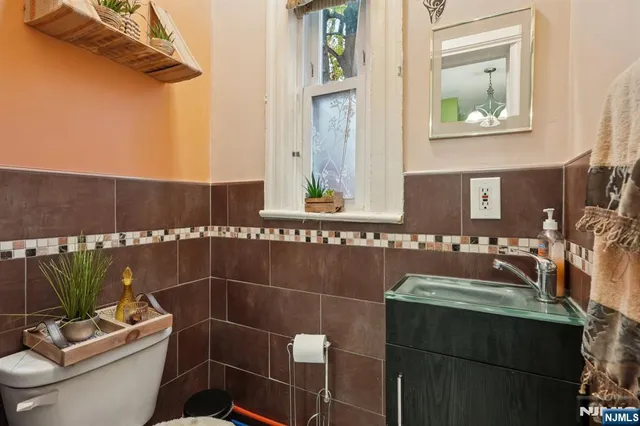 a bathroom with a sink a toilet and mirror