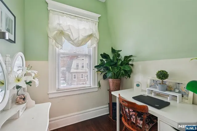 a table with a potted plant and a window