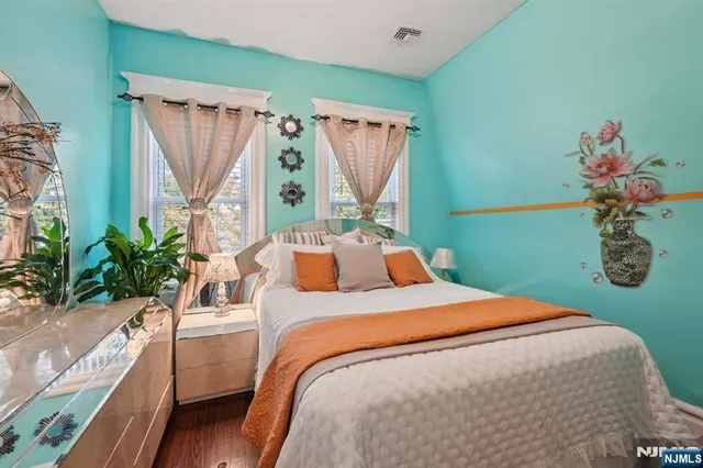 a bed sitting in a bedroom next to a window