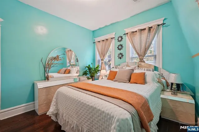 a bedroom with a bed window and a table