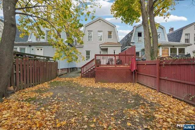 a view of a house with wooden fence