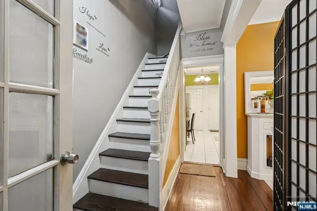 a view of a hallway with wooden floor and entryway