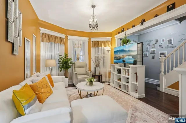 a living room with furniture and a chandelier