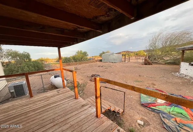 a view of a balcony with furniture and wooden floor