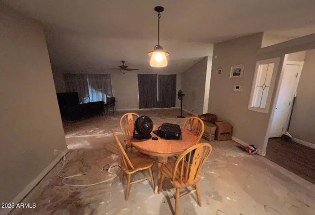 a view of a dining room with furniture and a chandelier