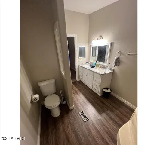 a bathroom with a sink toilet and mirror