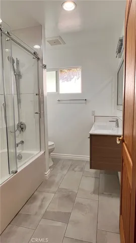 a view of a small space with wooden floor and a window