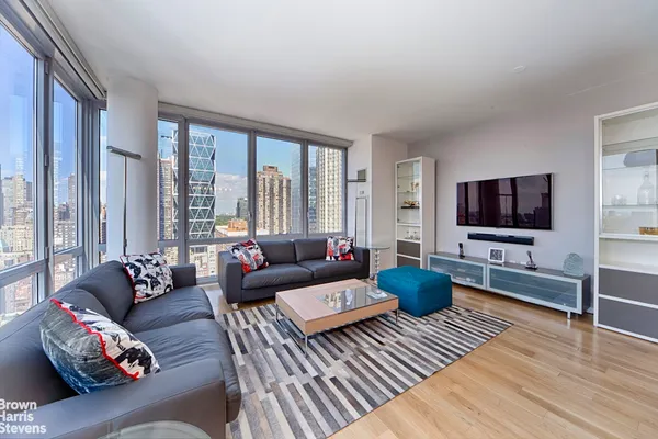 a living room with furniture and a flat screen tv