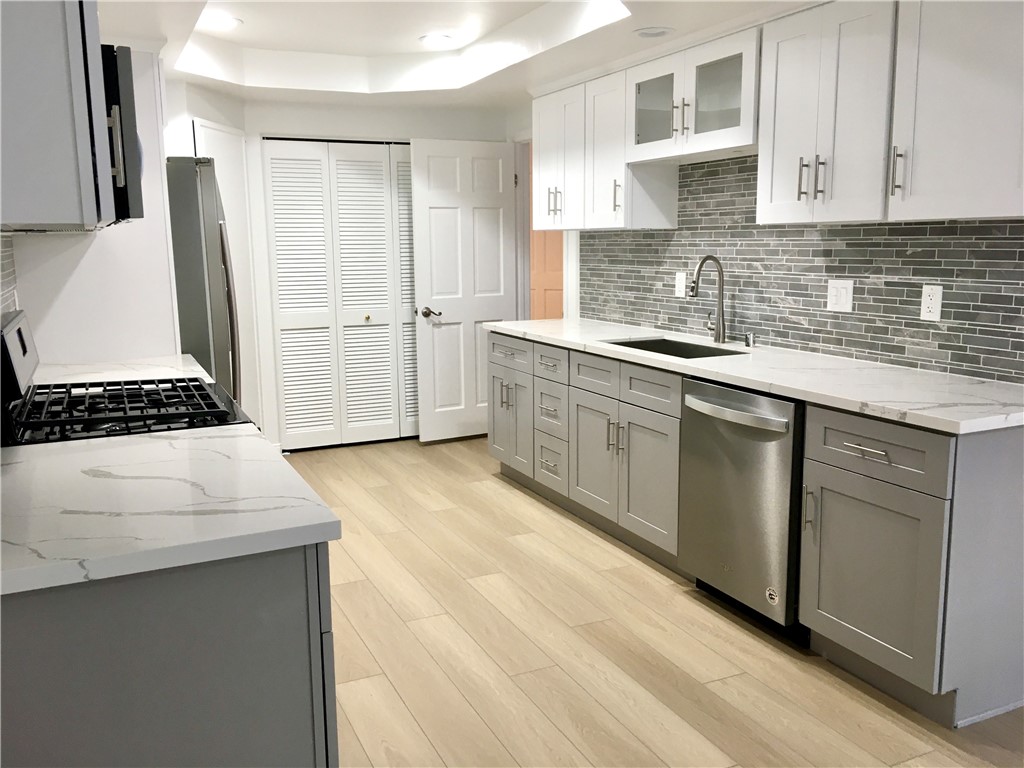a kitchen with cabinets and white appliances